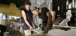 two men making wooden prop