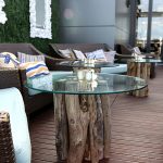 glass-topped table with driftwood legs